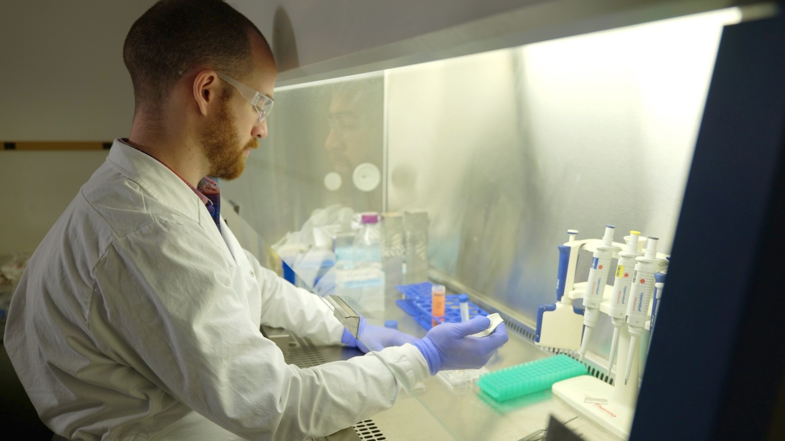 Image shows Bailey McFarland working in a fume hood.